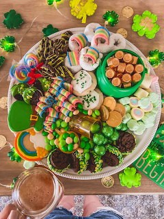 Overhead view of St. Patrick's Day themed dessert platter with cookies, candies, and rainbow treats