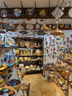 Pottery store interior with shelves of colorful hand-painted ceramic plates and bowls
