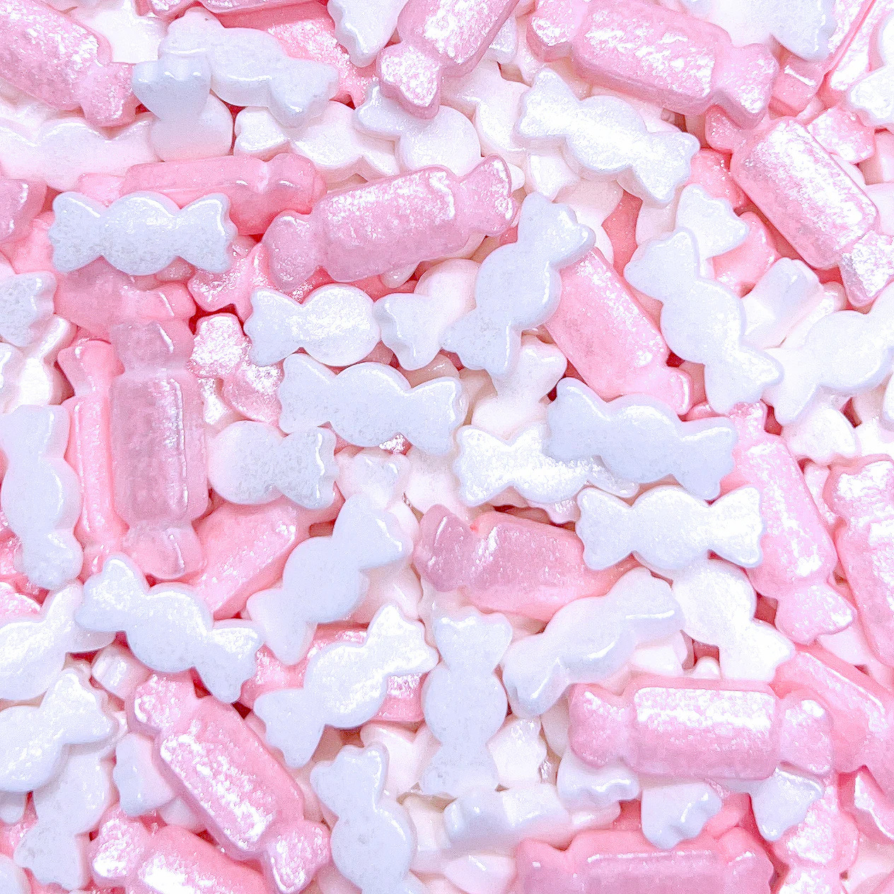 Close-up of pink and white bone-shaped candies filling the frame