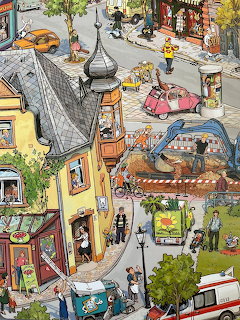 Colorful illustrated city scene showing buildings, streets, cars, and people from an aerial perspective