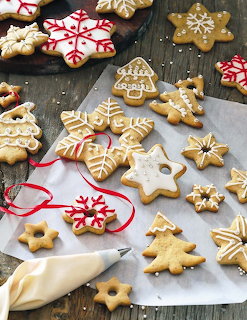 Decorated gingerbread cookies with white icing in a holiday setting