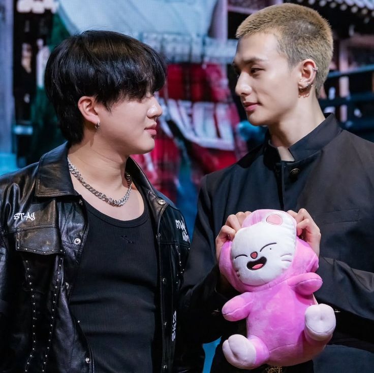Two Men Holding Plush