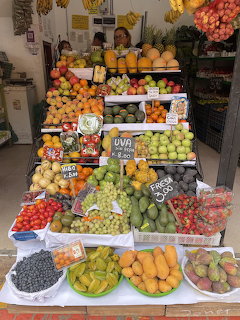 Colorful Peruvian market fruit stand with many varieties of fresh tropical fruits on display