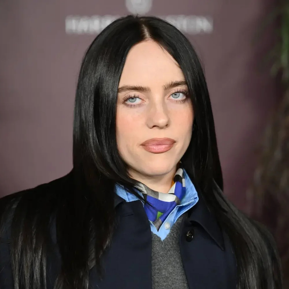 Portrait of Billie Eilish with long black hair and a blue scarf