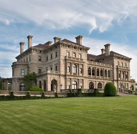 Large historic Vanderbilt mansion with ornate facade and green lawn