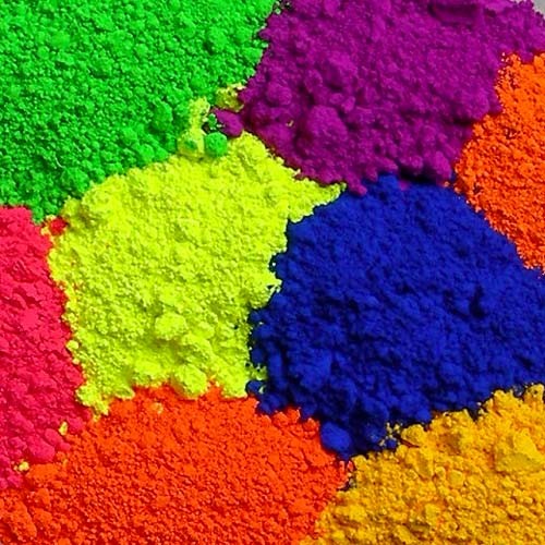 Bright colored powder pigments in multiple vivid hues arranged in piles