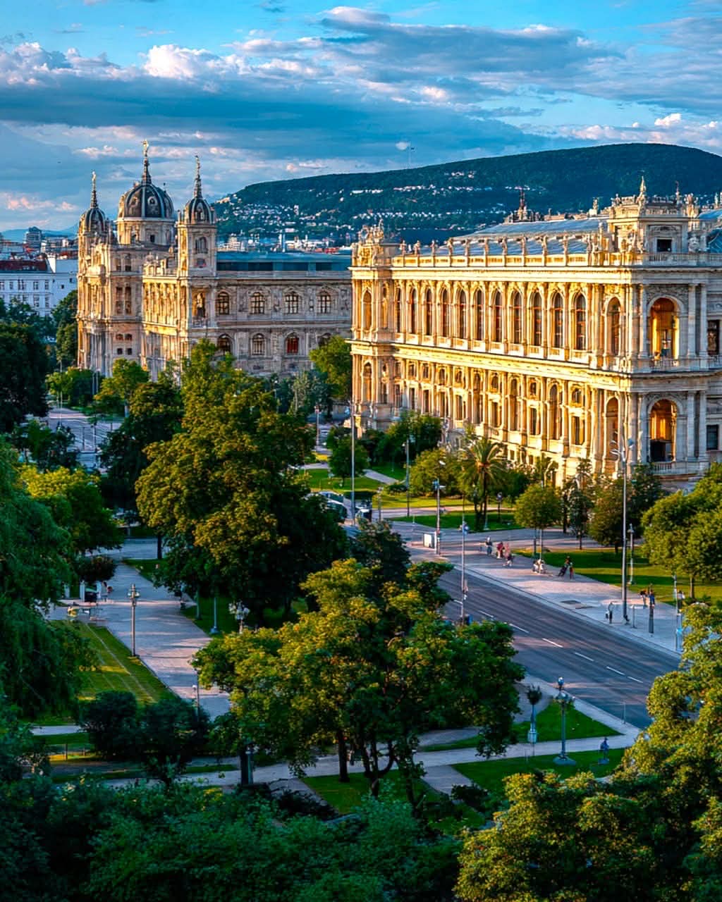 Vienna historic buildings with domed architecture surrounded by parks at sunset
