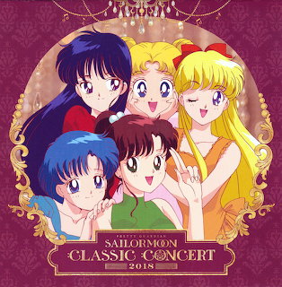 Four Sailor Moon anime characters in a decorative oval frame on a purple background