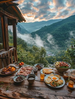 Breakfast table with eggs, bacon, and fruit overlooking misty mountain valley from a wooden cabin porch