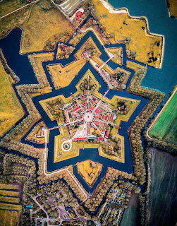 Aerial view of star-shaped fortress with angular bastions and water moats