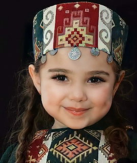 Smiling young girl wearing traditional folk costume with embroidered headband and collar