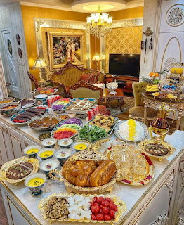 Elaborate Persian food spread with dozens of dishes on a table in a golden ornate room
