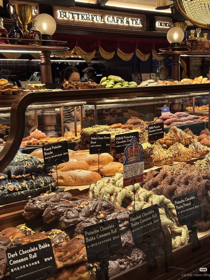 Bakery display case with assorted pastries, breads, and desserts arranged on multiple shelves