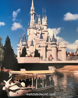 Cinderella Castle at Disney World Magic Kingdom with swan boat in foreground under blue sky