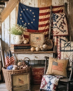 Vintage Americana display with Betsy Ross flag, old baseballs, quilts, and rustic wooden crates