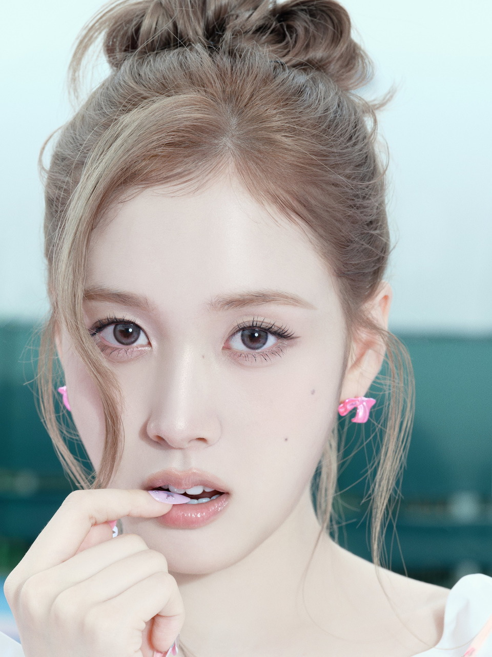 Portrait of young woman with updo hairstyle and natural makeup looking at camera
