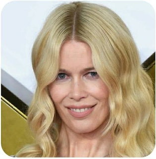 Close-up portrait of a smiling blonde woman with long wavy hair