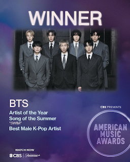 Purple poster showing BTS in suits with winner text and an American Music Awards badge.