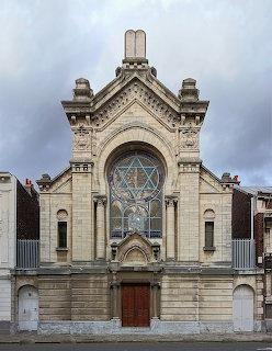 Historic synagogue building facade in Lille, France with ornate architectural details and central entrance