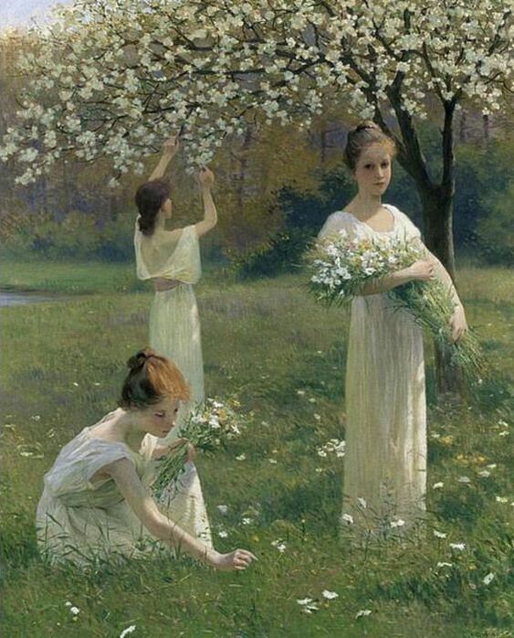Three women in white dresses picking flowers in a spring meadow under blooming trees