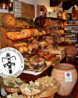 Rustic Italian cheese shop interior with pecorino wheels, jars, baskets, and wooden shelves