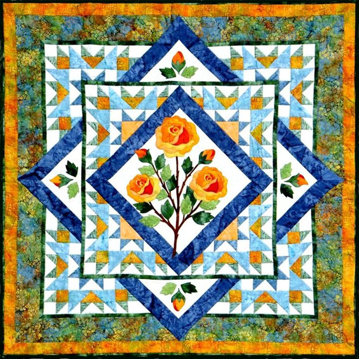 Square patchwork quilt pattern with yellow roses in the center and blue diamond borders