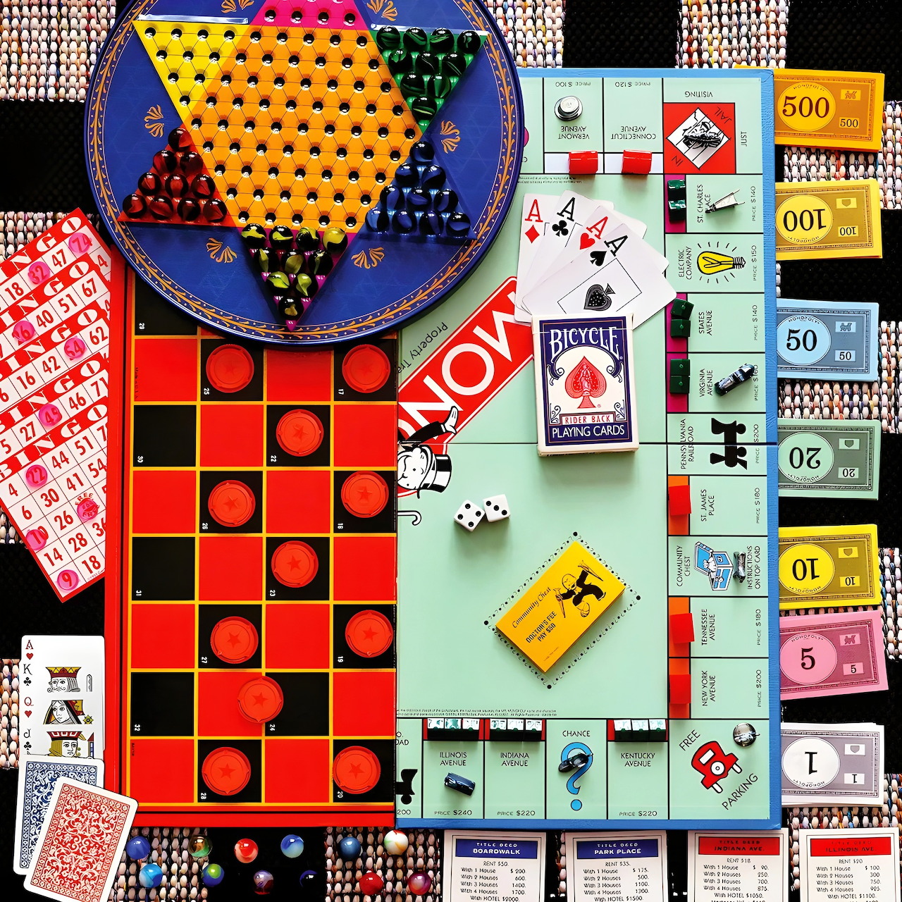 Overhead view of board games with cards, dice, tokens, and colorful game boards