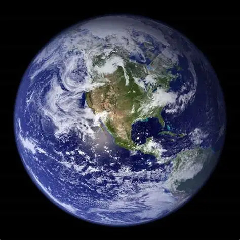 Satellite photo of Earth showing North America, blue oceans, and white clouds on black space background