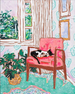 Black and white cat resting on pink armchair in bright interior with plants and window