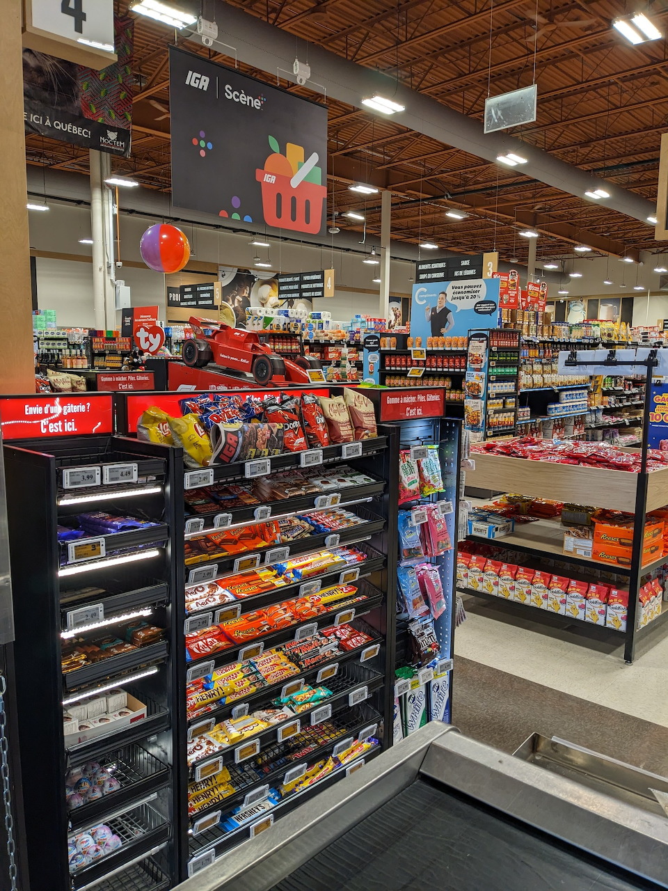 Supermarket interior showing candy and snack aisle with product displays