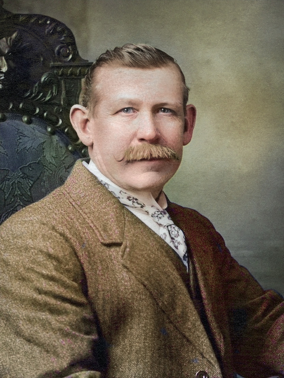 Vintage hand-colored portrait of a mustachioed man in brown suit and ornate chair, circa 1892