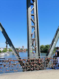 Steel bridge beams with love locks overlooking a river on Frankfurt's Eiserner Steg