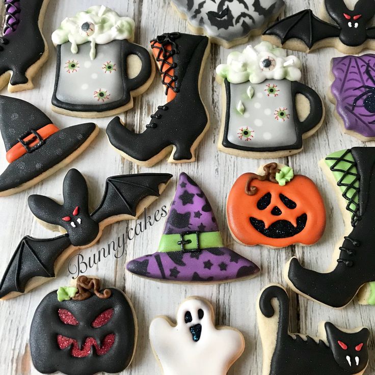 Assorted Halloween cookies with orange pumpkins, white ghosts, black witch hats and boots, and gray cauldrons