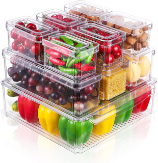 Stacked clear plastic containers filled with colorful fresh vegetables and fruits organized in refrigerator storage bins