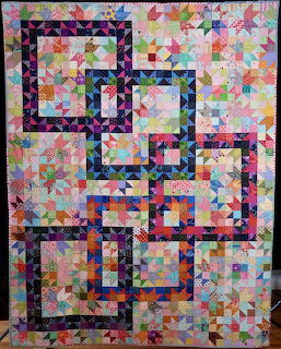 Geometric quilt with dark star outlines on pastel patchwork background