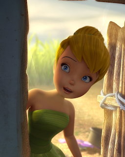 Blonde fairy character in green dress looking through wooden door