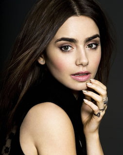 Close-up portrait of Lily Collins with dark hair and hand near her face