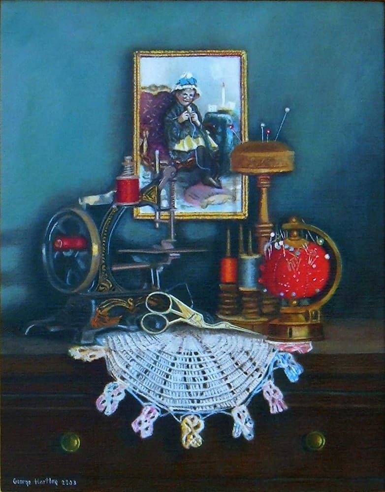Vintage sewing items arranged as still life with scissors, thread, pincushion, and decorative lace on dark surface