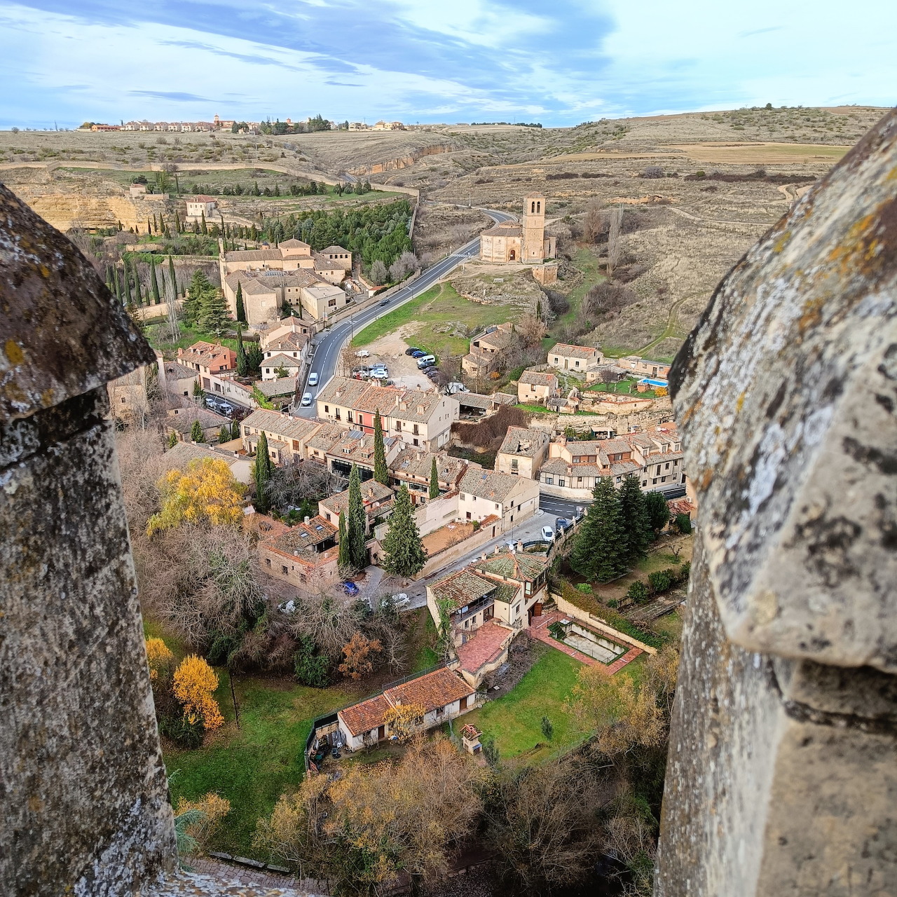 Historic village of Segovia with church tower and stone buildings viewed from fortress walls