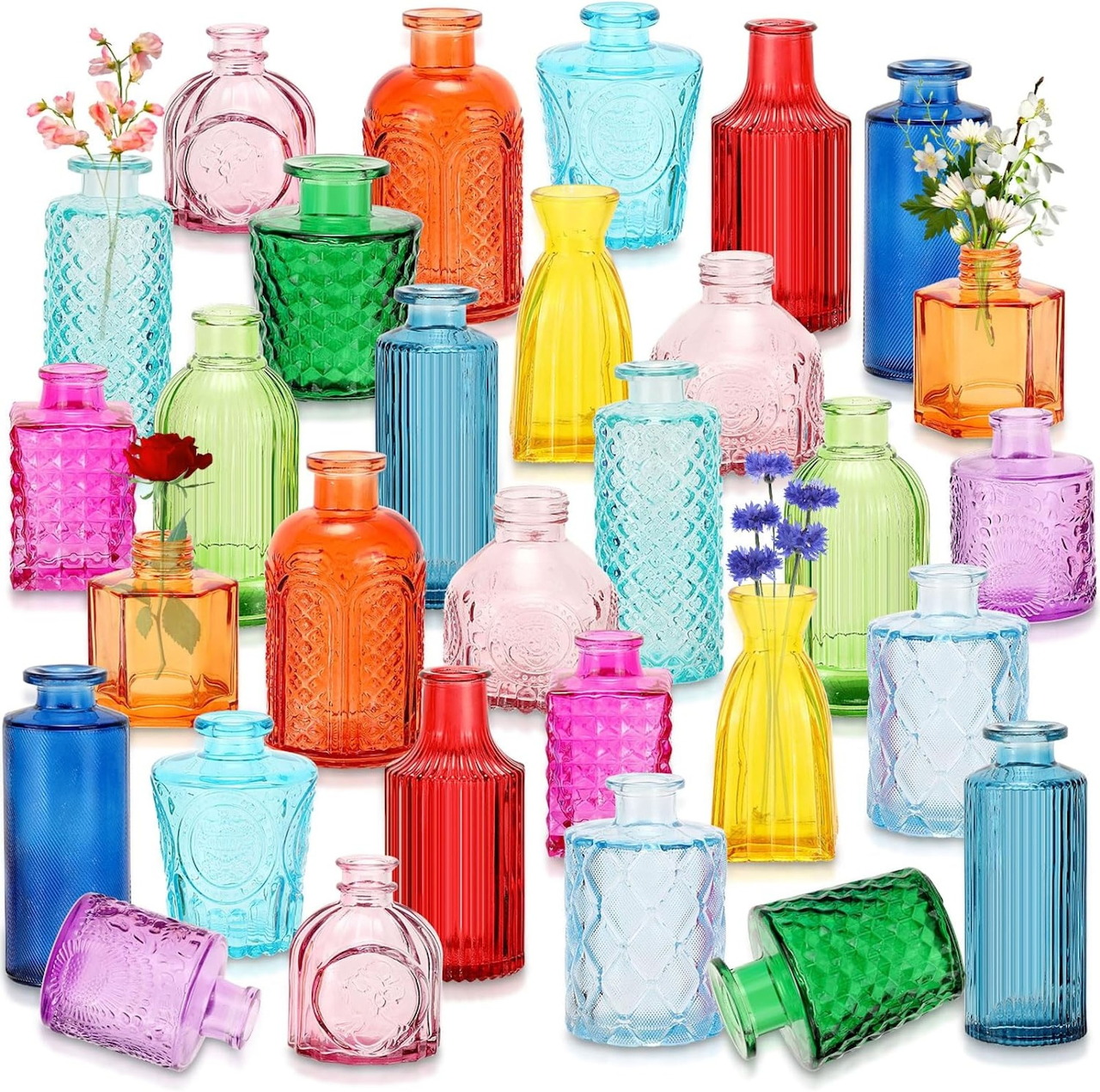 Assorted colorful glass vases and bottles in various shapes and bright colors on white background
