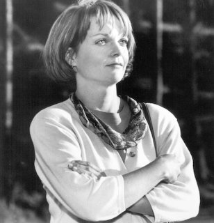 Black-and-white portrait of a woman with short hair and folded arms