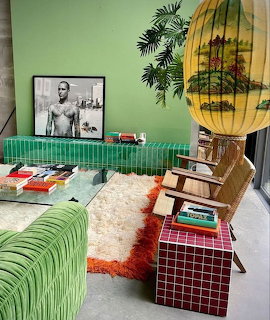 Retro living room with green sofa, yellow lamp, checkered furniture and vintage decor