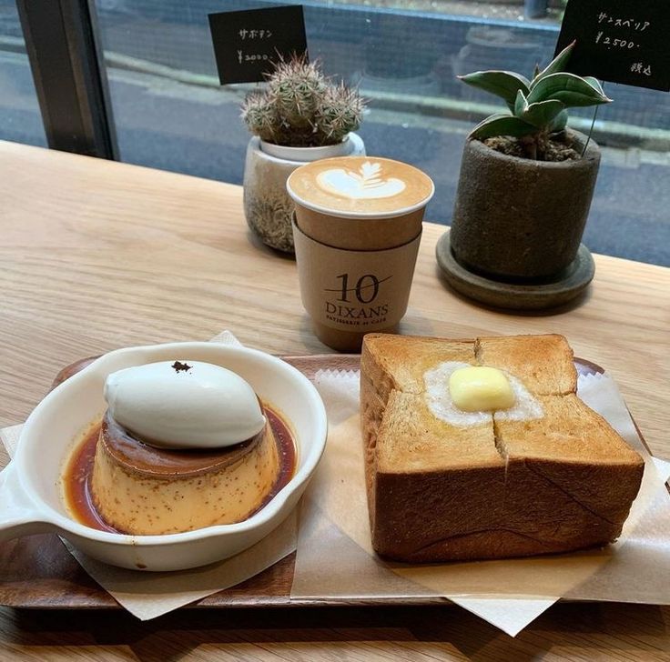 Cafe table with latte, purin custard, thick toast, and plants