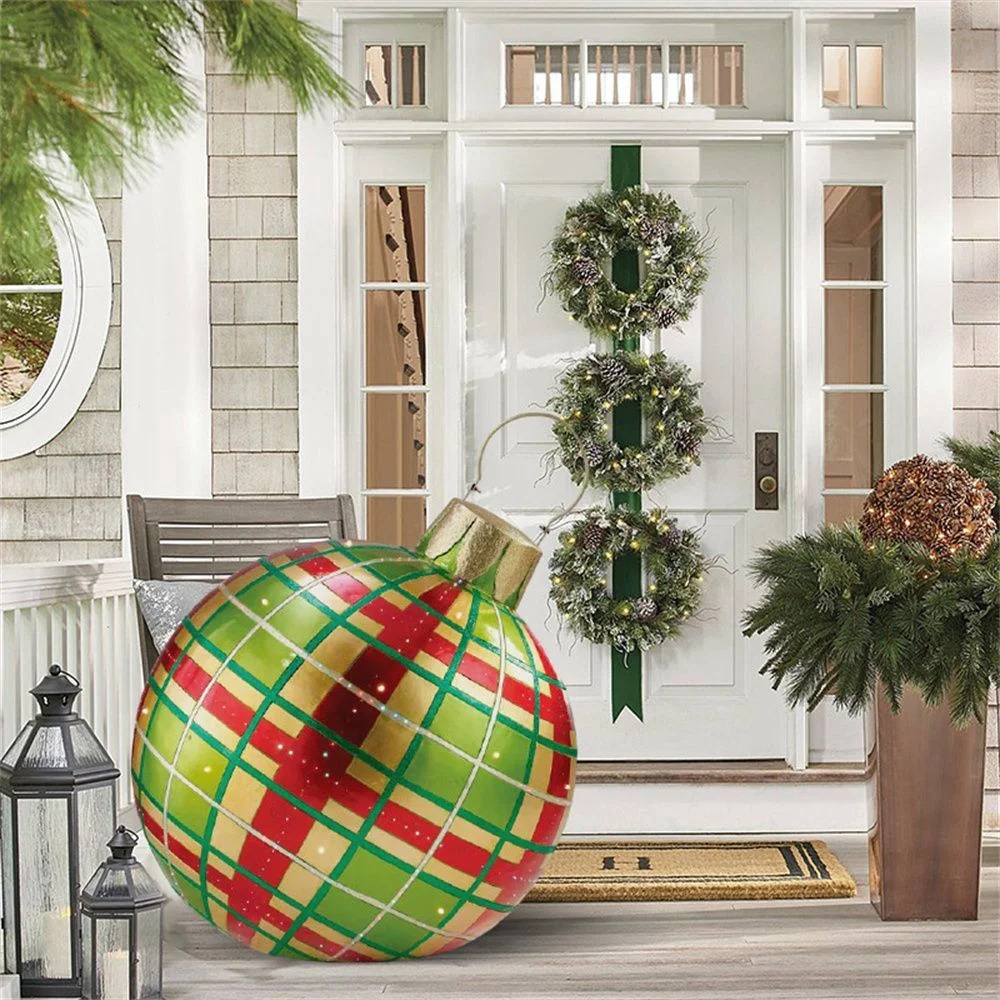 Large plaid Christmas bauble on a decorated front porch with wreaths and lanterns