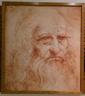 Red chalk drawing of an elderly bearded man with long hair, attributed to Leonardo da Vinci