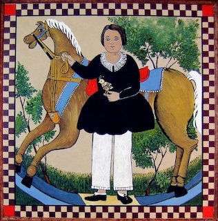 Folk art painting of woman in black dress with white apron standing next to yellow hobby horse on checkered border
