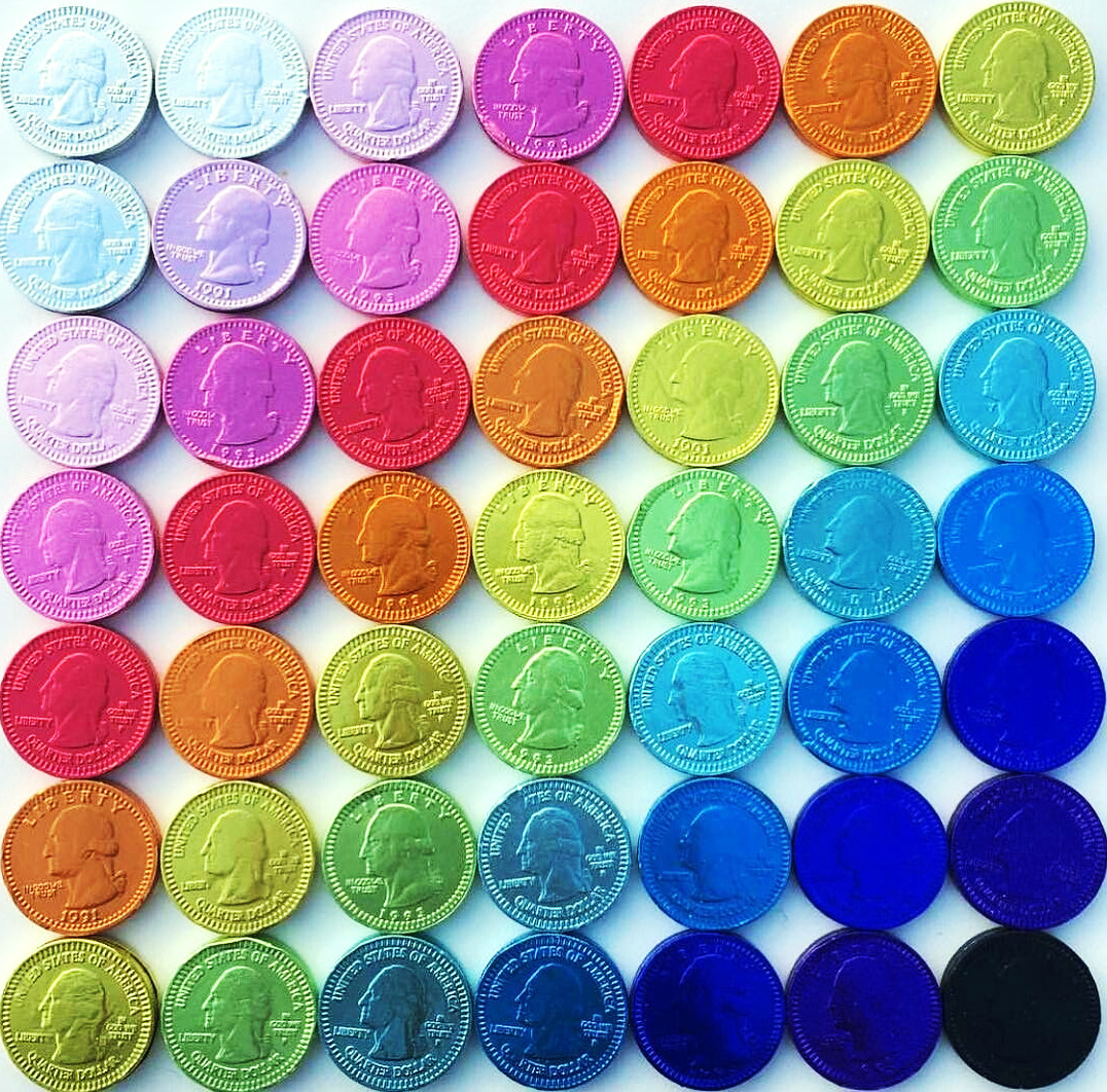 Grid of colorful poker chips arranged by color in rows, showing rainbow spectrum from pastels to deep blues