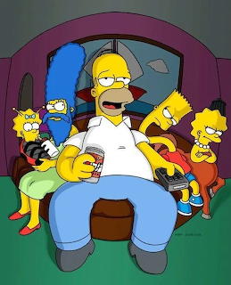 The Simpson family seated on their purple couch with Homer in the center surrounded by Marge, Bart, Lisa, and Maggie