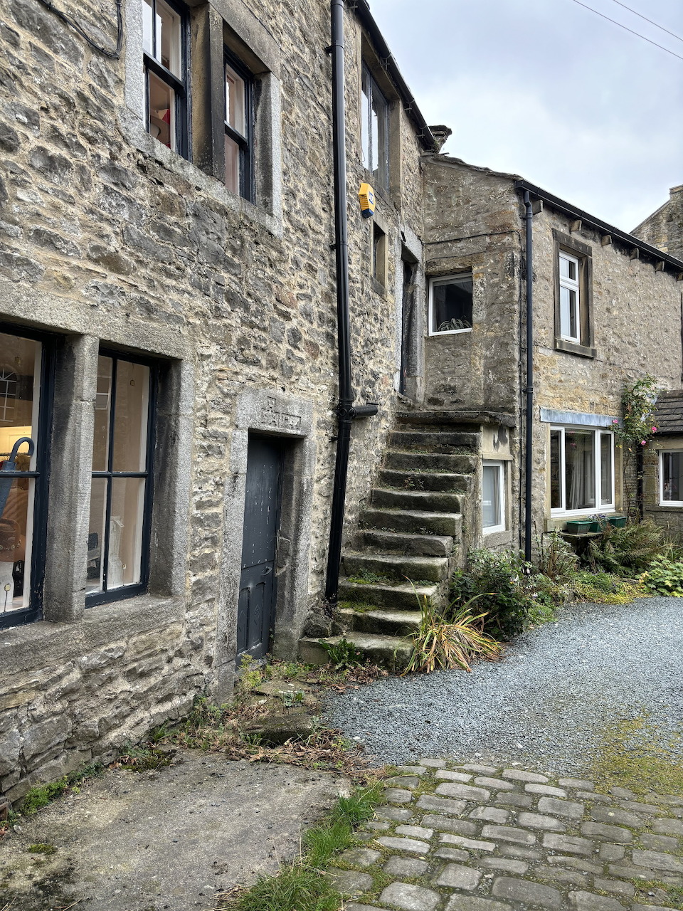 Stone cottages with external stone staircase in a quiet village courtyard