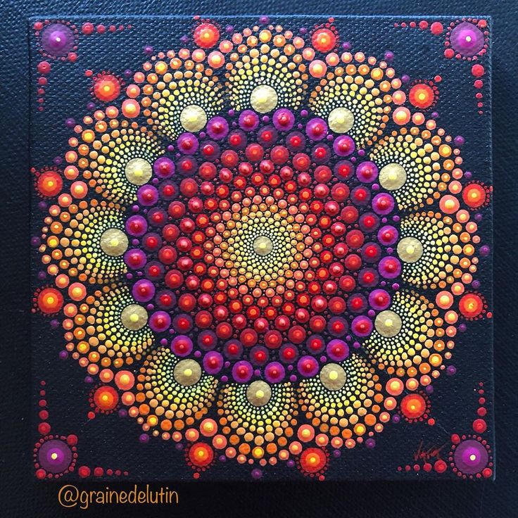Circular mandala with colorful dots radiating in symmetrical pattern on dark background
